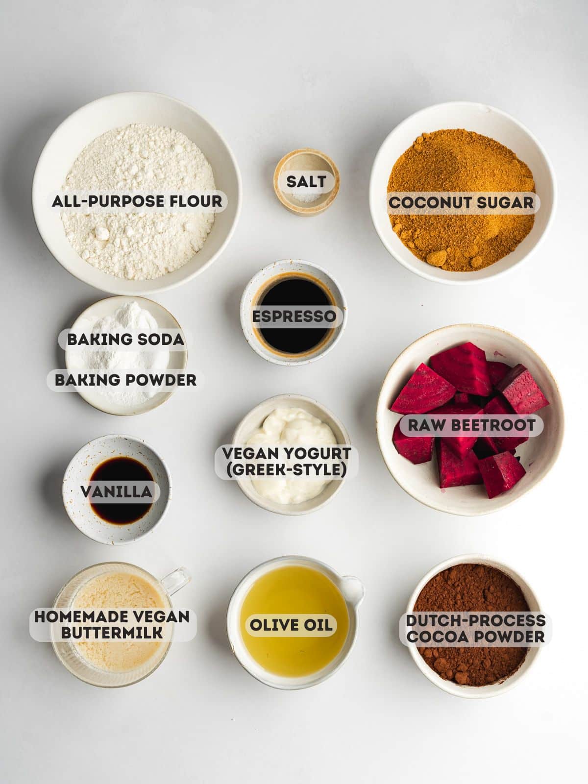 ingredients for beetroot chocolate cake measured out in bowls on a gray surface.