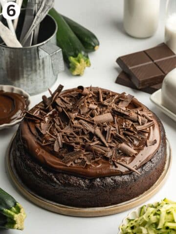 chocolate courgette cake topped with vegan ganache and chocolate curls.