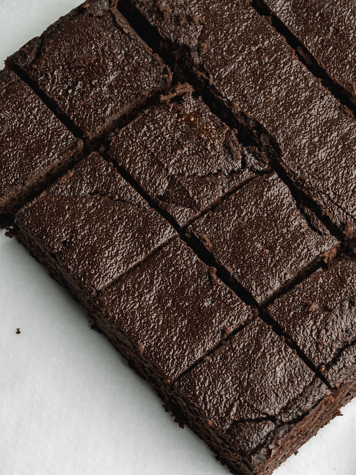 beetroot brownies being sliced into small squares.