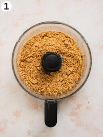 biscuits blended into a crumbs in a food processor jug.