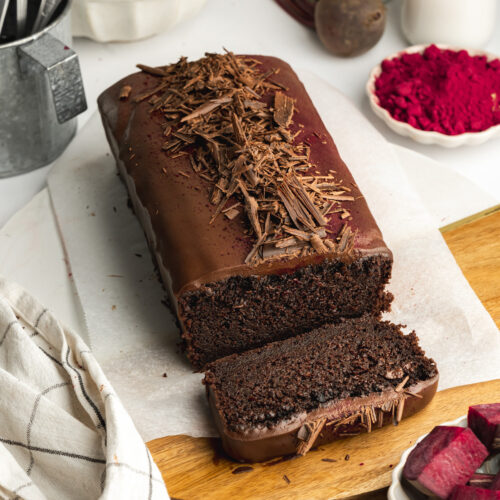 a beetroot chocolate loaf cake with ganache topping, and a slice cut showing the moist interior.