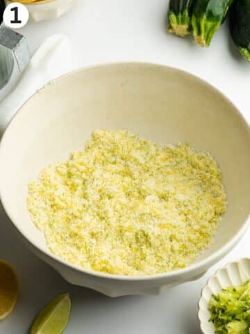 sugar with fresh lemon and lime zest rubbed into it in a large ceramic bowl.