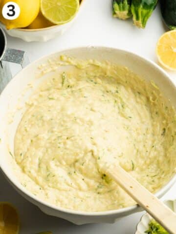 courgette lemon cake batter in a mixing bowl with a rubber spatula.