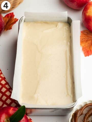 creamy apple cheesecake in a lined loaf pan before going into the fridge to set.