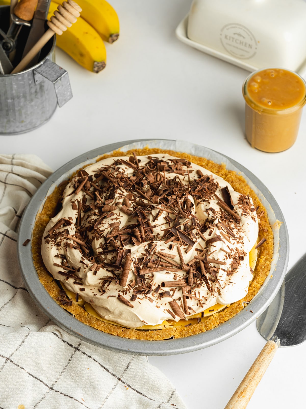 vegan banoffee pie topped with espresso whipped cream and chocolate shavings.