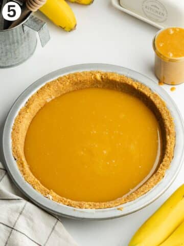 cookie crust filled with toffee sauce before going into the fridge to set.