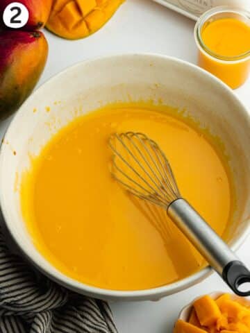 wet ingredients for mango cake whisked in a large bowl.