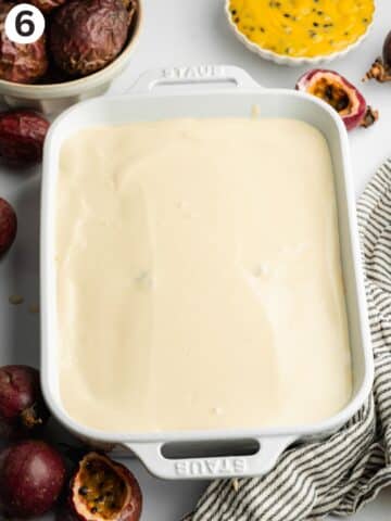 passion fruit tiramisu in a staub dish before going into the fridge to set.
