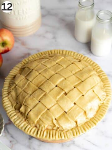 apple pie with lattice design and demerara sugar on top before baking.