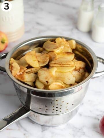 macerated apples in a colander to separate the juices.