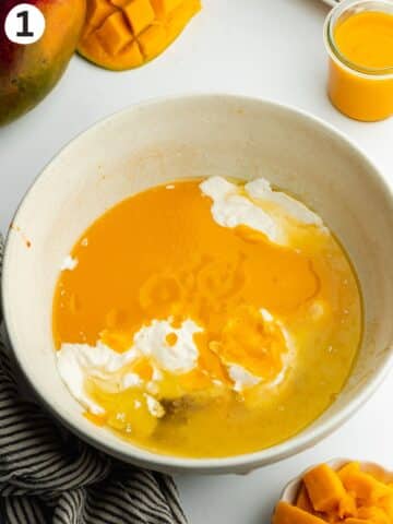 mango puree, oil, melted butter, sugar, and yogurt in a bowl before mixing.