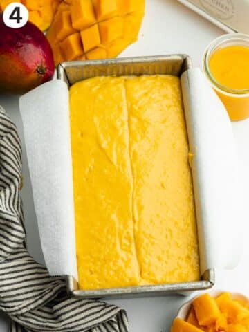 mango cake batter in a loaf pan before baking.