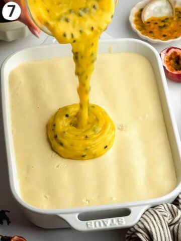 pouring passionfruit curd on top of a tiramisu.