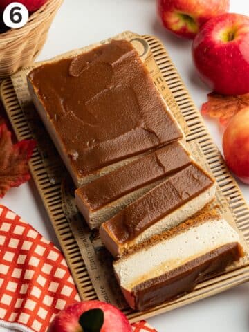 a rectangular apple cheesecake with apple butter topping and a few slices cut.