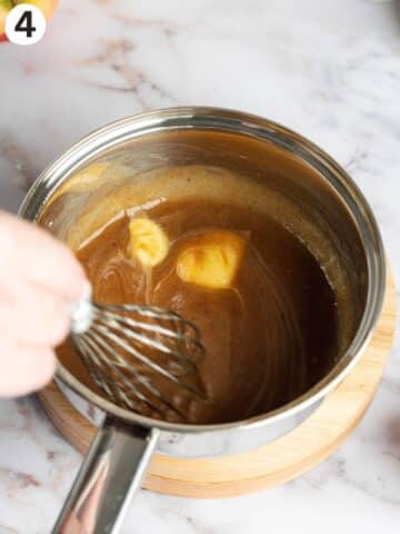 whisking butter into apple reduction for apple pie filling.