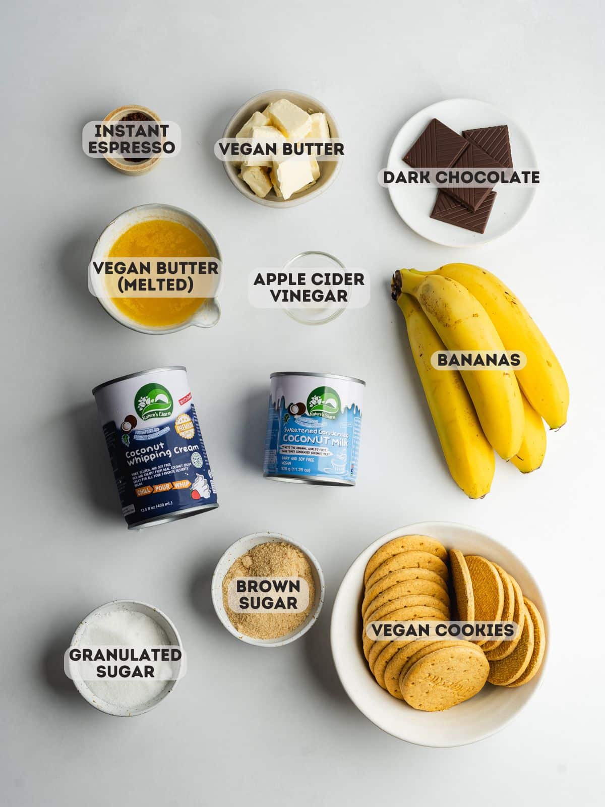 ingredients for banoffee pie measured out in bowls on a gray surface.