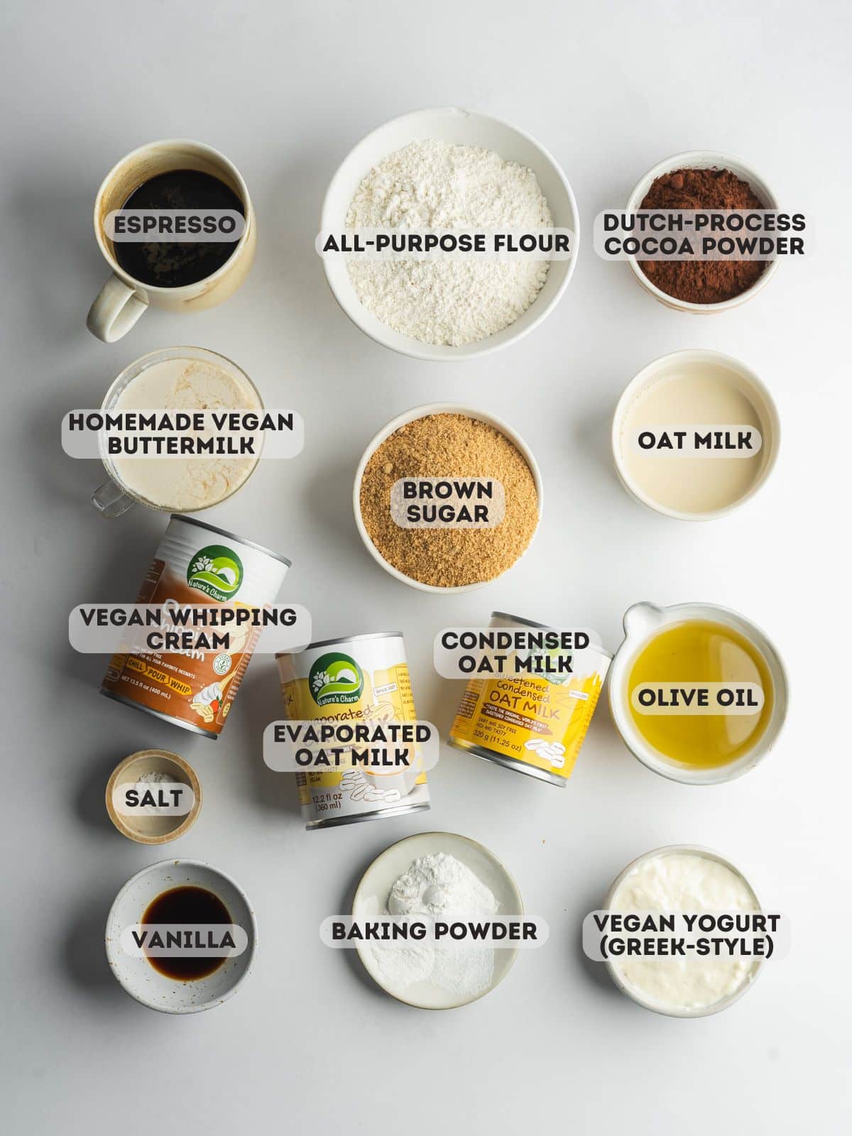 ingredients for chocolate tres leches cake measured in bowls.