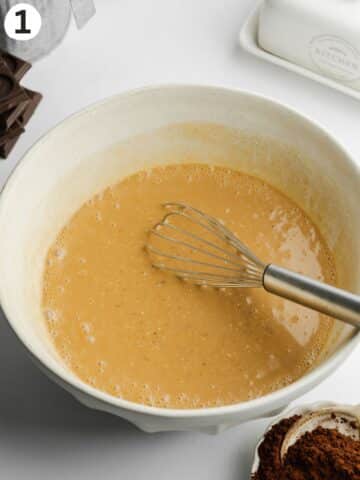 brown sugar, dairy-free buttermilk, vanilla, and olive oil whisked in a ceramic bowl.