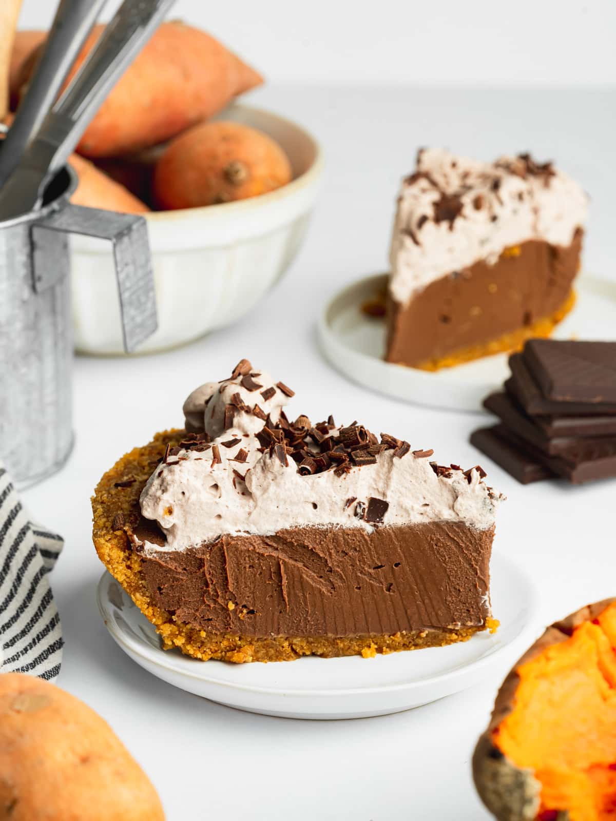 a slice of chocolate sweet potato pie with cocoa whipped cream on a plate.