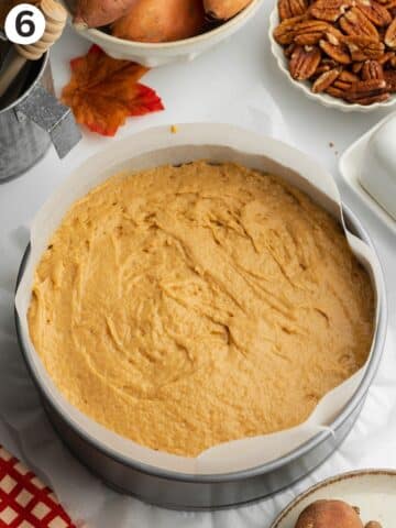 sweet potato cake in a lined cake before being topped with crumble.