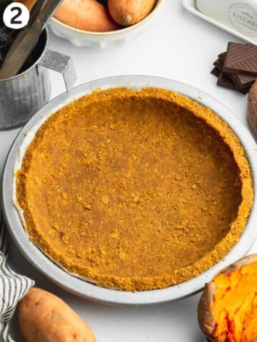 cookie crust pressed into a lined pie tin.