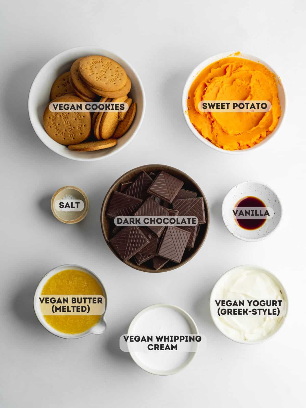 ingredients for chocolate sweet potato pie measured out in bowls on a gray surface.