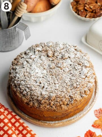 sweet potato coffee cake on a ceramic plate dusted with powdered sugar.