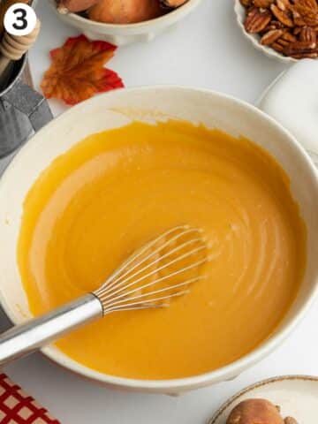 sweet potato cake wet ingredients whisked into a smooth paste in a ceramic bowl.