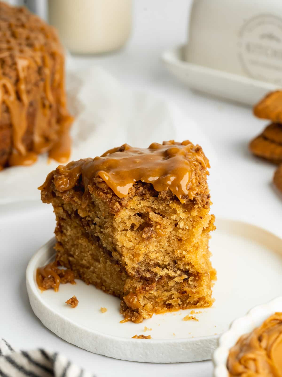 a slice of biscoff coffee cake with a forkful taken from it showing the moist interior.