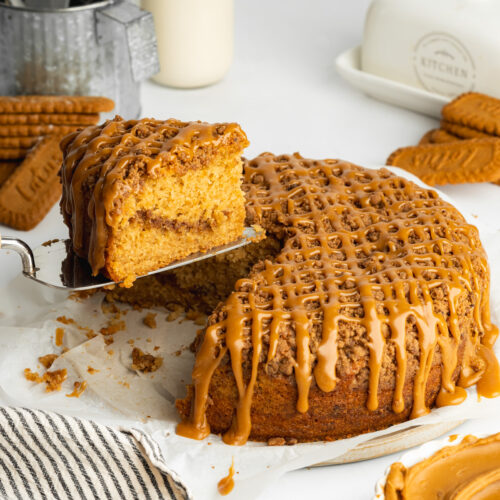 biscoff coffee cake with a slice being lifted away on a cake slice.