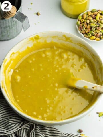 pistachio fudge mixture melted in a large ceramic bowl.