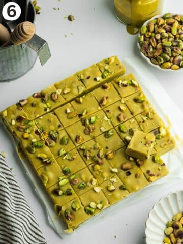 a slab of pistachio fudge cut into small squares.