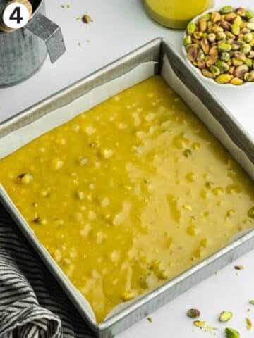 pistachio fudge mixture in a lined square pan.