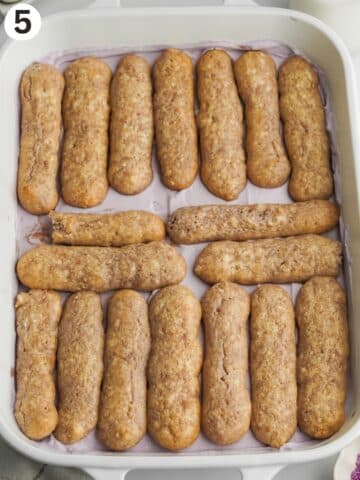 a second layer of ladyfingers on top of ube mascarpone cream in a staub dish.