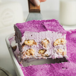 a slice of purple ube tiramisu being lifted up on a cake slice.