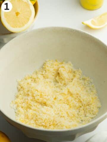 lemon zest rubbed into sugar in a ceramic bowl.
