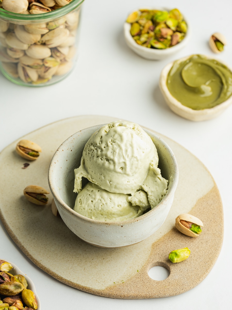 scooped pistachio ice cream in a ceramic bowl.