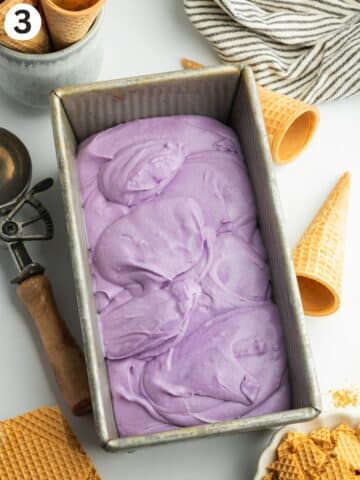 a loaf pan with ube ice cream before freezing.