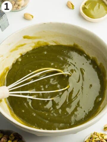 pistachio cream, condensed milk, vanilla, and amaretto whisked in a ceramic bowl.
