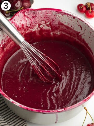 cherry curd whisked in a saucepan.