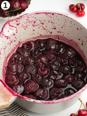 cherries cooked in sugar and lemon juice in a pan.