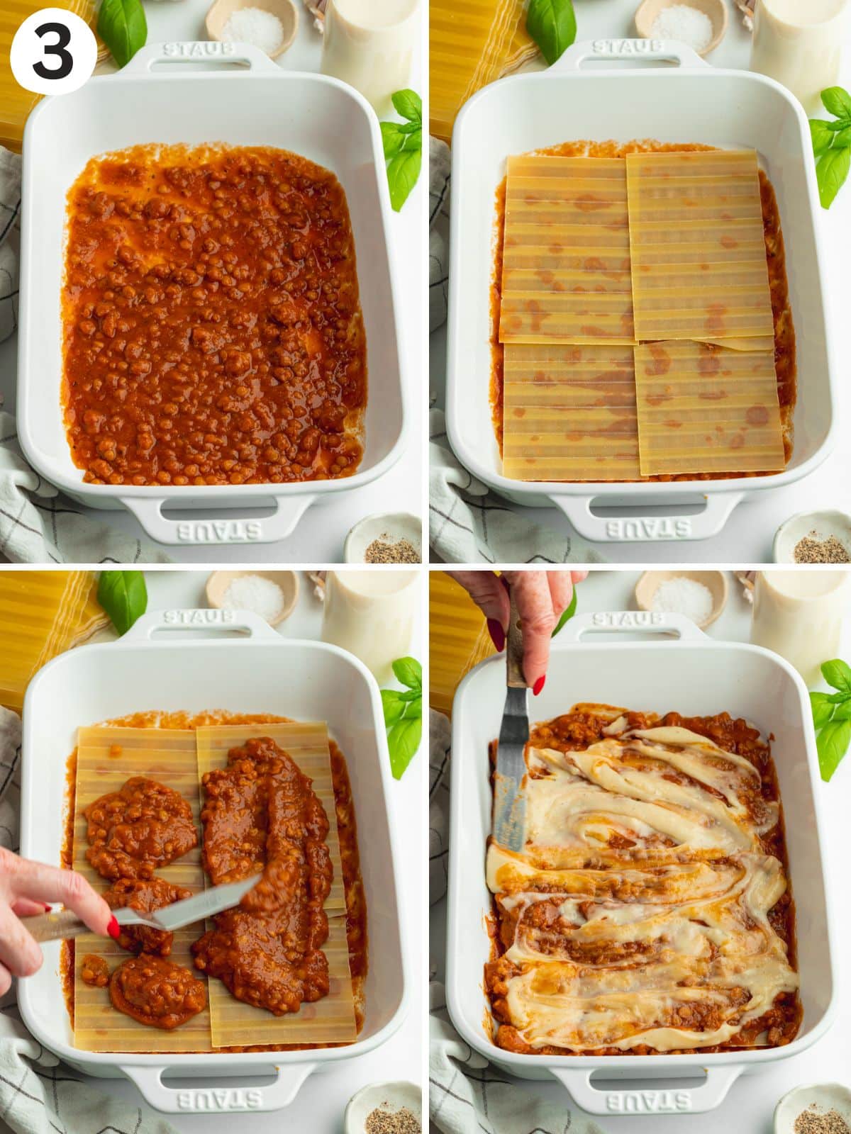 assembling vegan lasagna in a white staub pan.