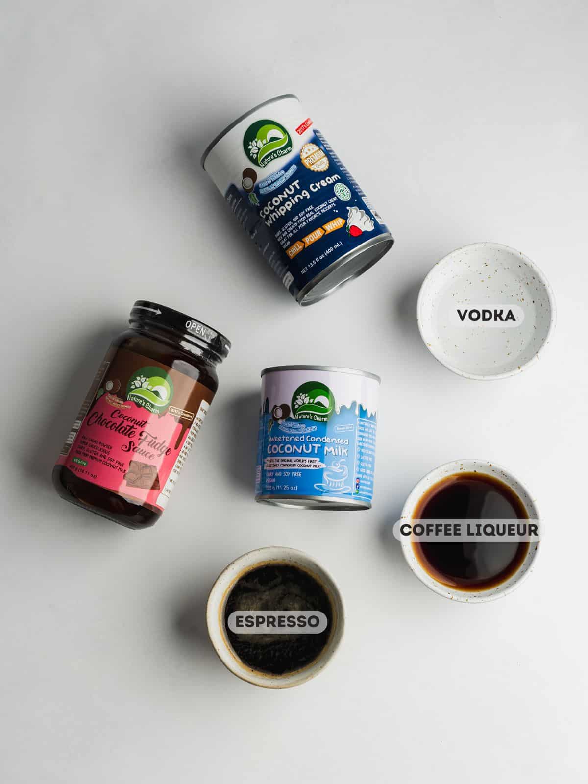 ingredients for espresso martini ice cream measured out in bowls on a gray surface.