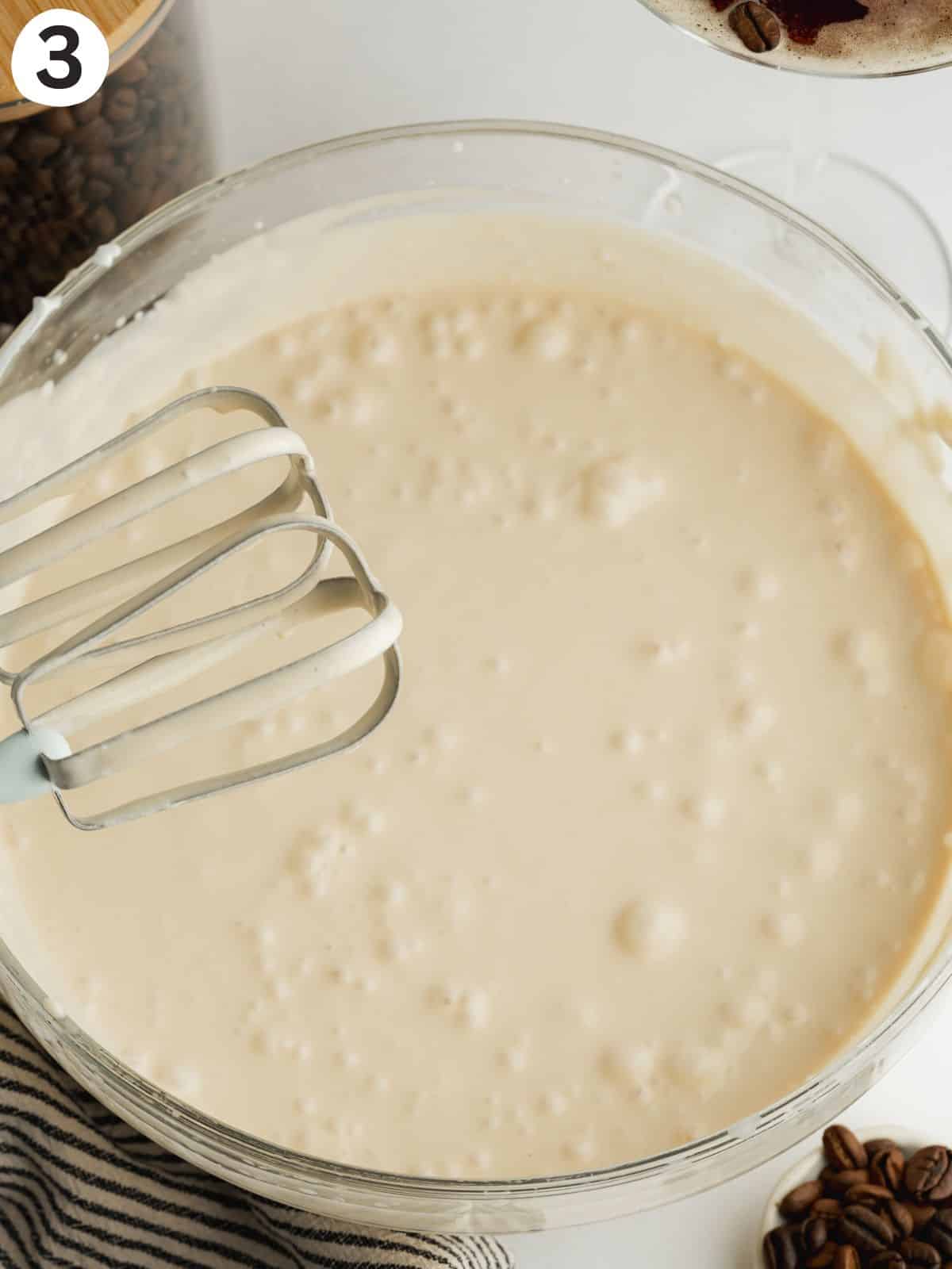 coffee ice cream whisked in a bowl before going into the ice cream maker.