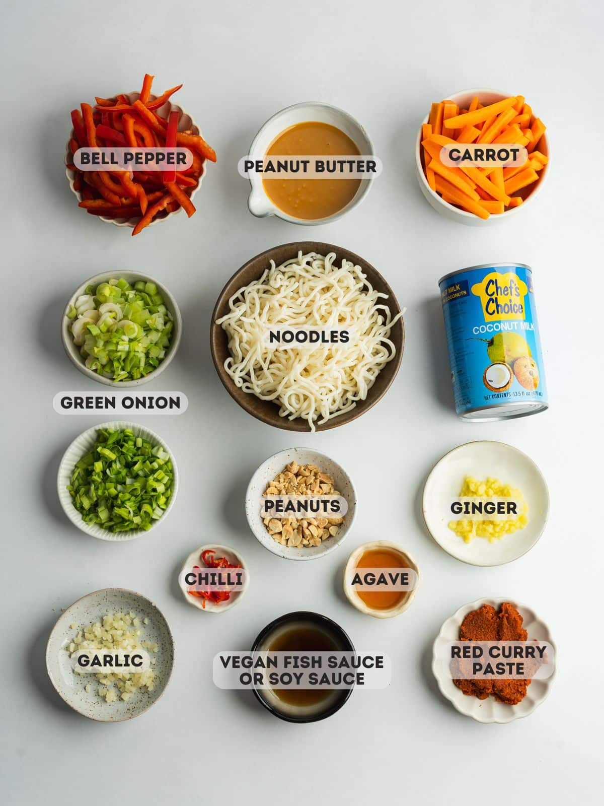 ingredients for red curry noodles measured out in bowls.