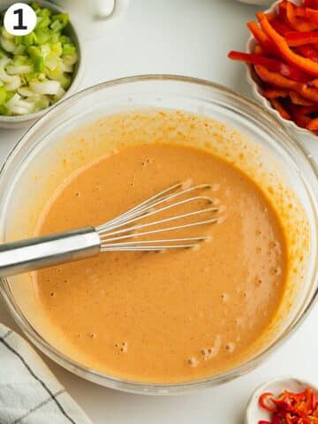 peanut butter coconut red curry sauce whisked in a bowl.