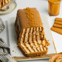 a biscoff icebox cake made in a loaf pan with vertical cookies and biscoff cream.