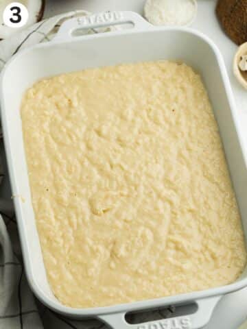 coconut tres leches cake batter in a staub dish before baking.