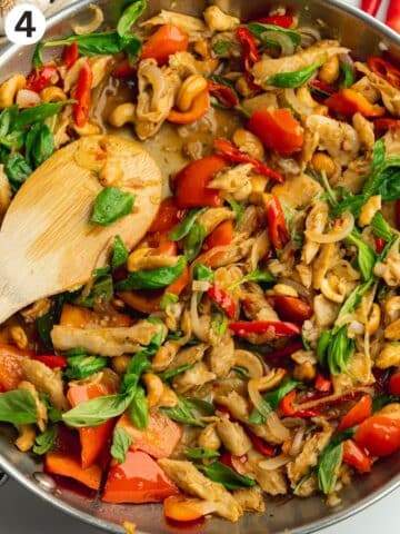 cooked vegan thai basil chicken in a stainless steel pan.