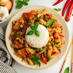 a bowl of vegan thai basil chicken with rice in the center.